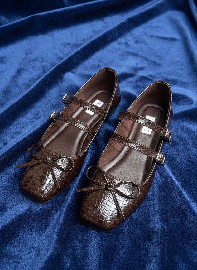 Pair of brown shoes with 'BASIC' label on a gray surface