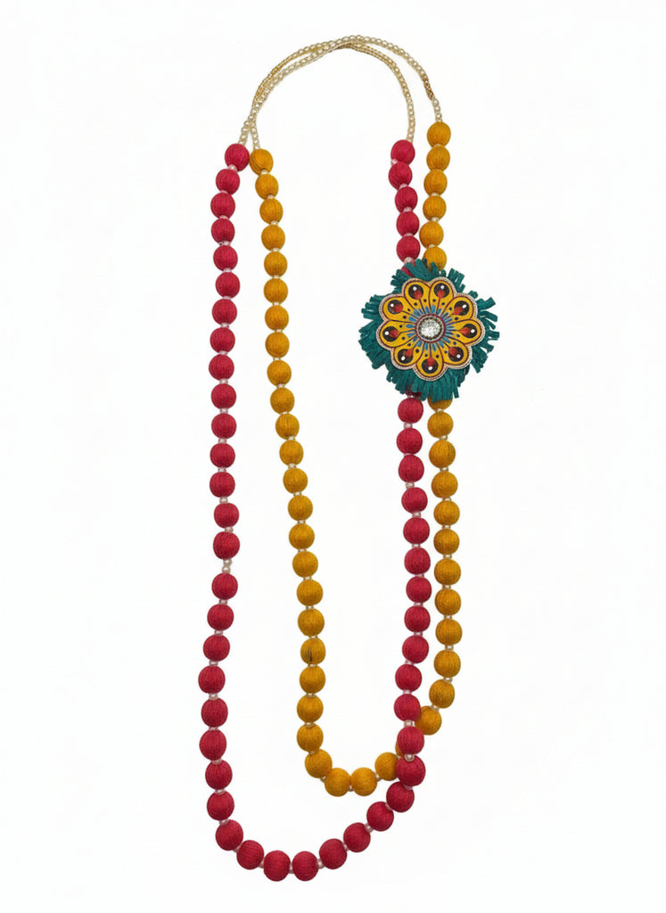 Colorful beaded necklace with a decorative clasp on a wooden surface