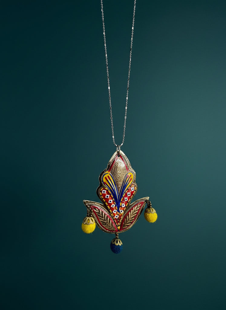 Decorative necklace with a colorful pendant on a textured beige background