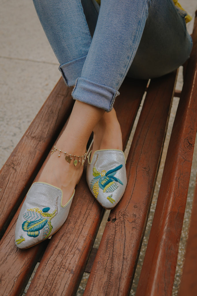 Neon thread colored embroidered motif on pointed glittery mule 