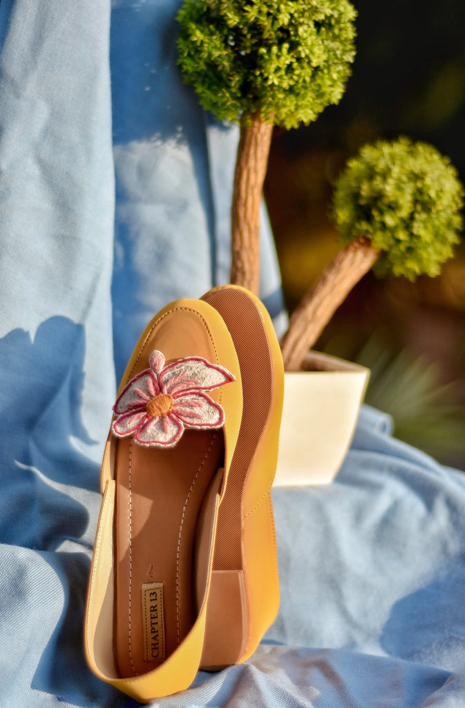 Yellow color khussa style loafer with a applique flower on top