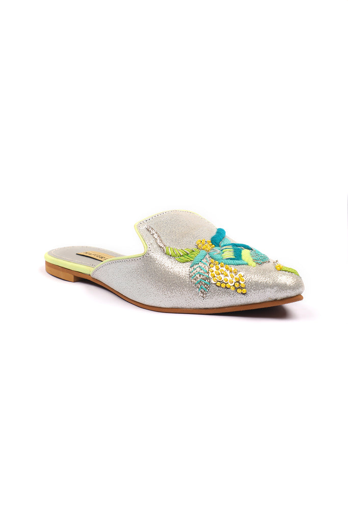Neon thread colored embroidered motif on pointed glittery mule 