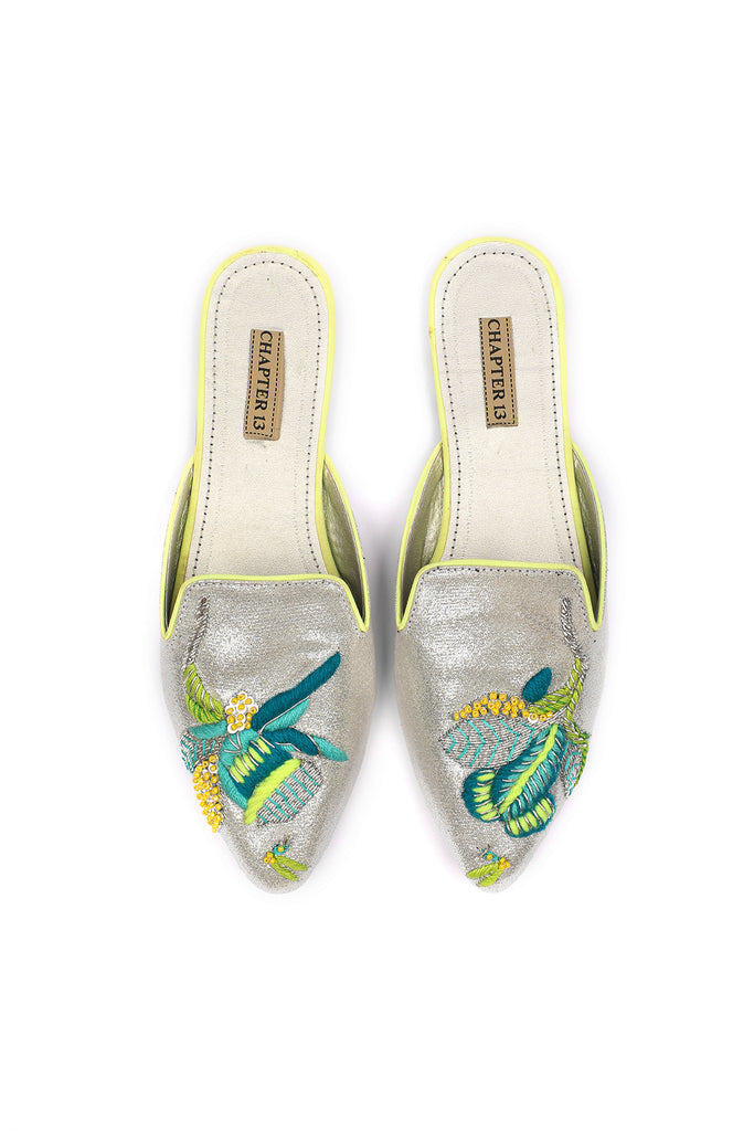 Neon thread colored embroidered motif on pointed glittery mule 